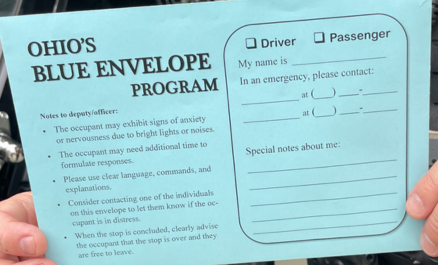 Image of a person holding a blue envelope